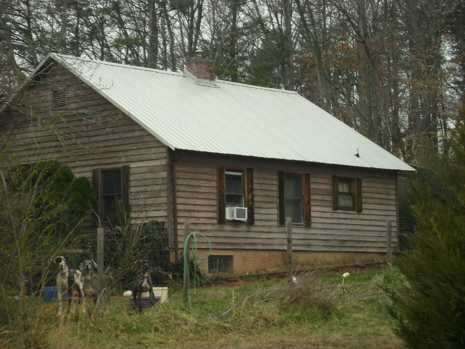 White metal roof on an old wood sided farmhouse, from a Metal Roof Installation job in Leominster